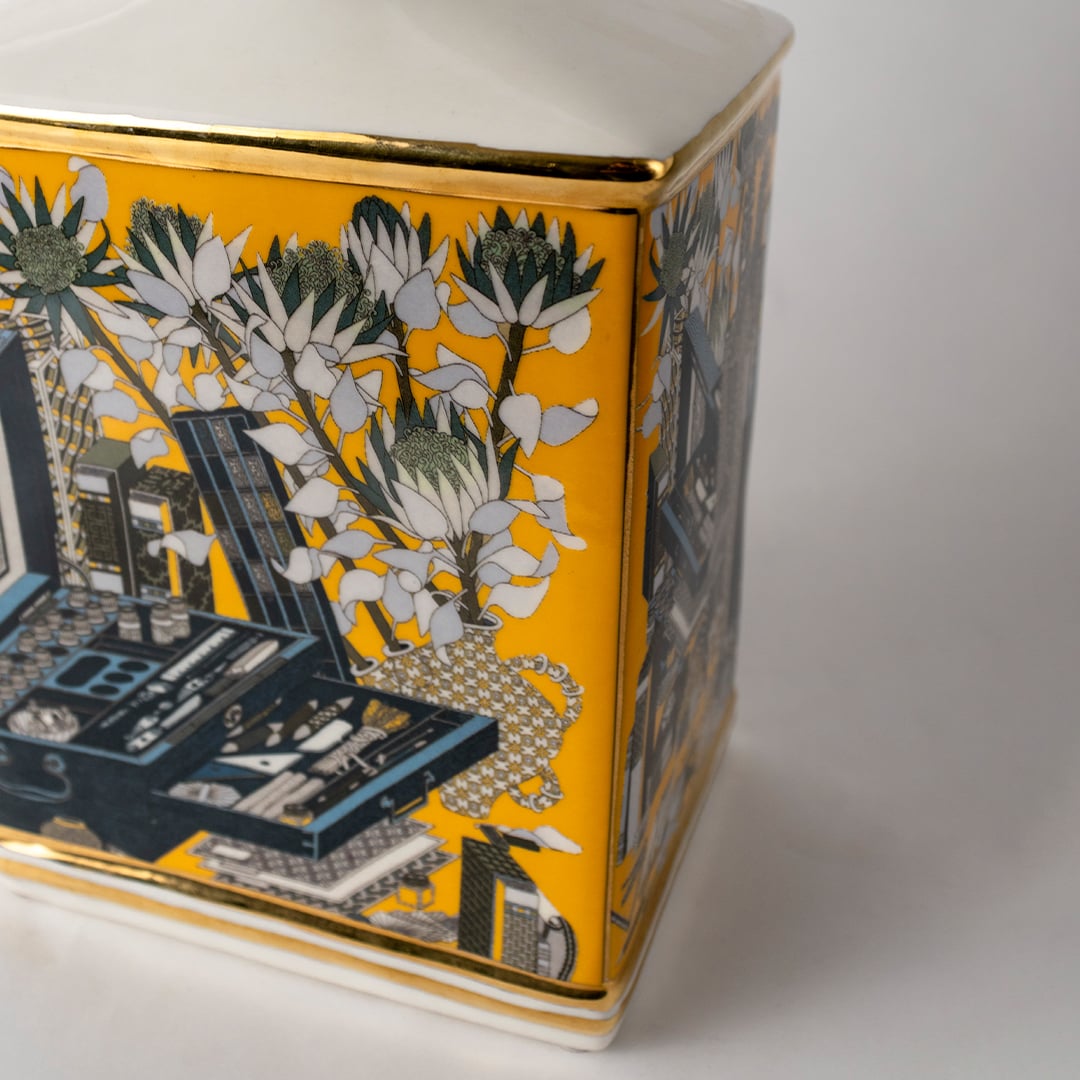 Yellow and grey ceramic jar with city and floral artwork in a close-up view perfect for classic décor styling and bold accent display.