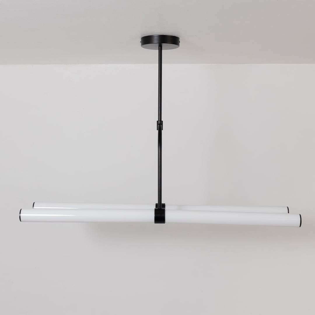 Chandelier with lights off on a white background displaying its minimalist linear form and elegant suspended rods.