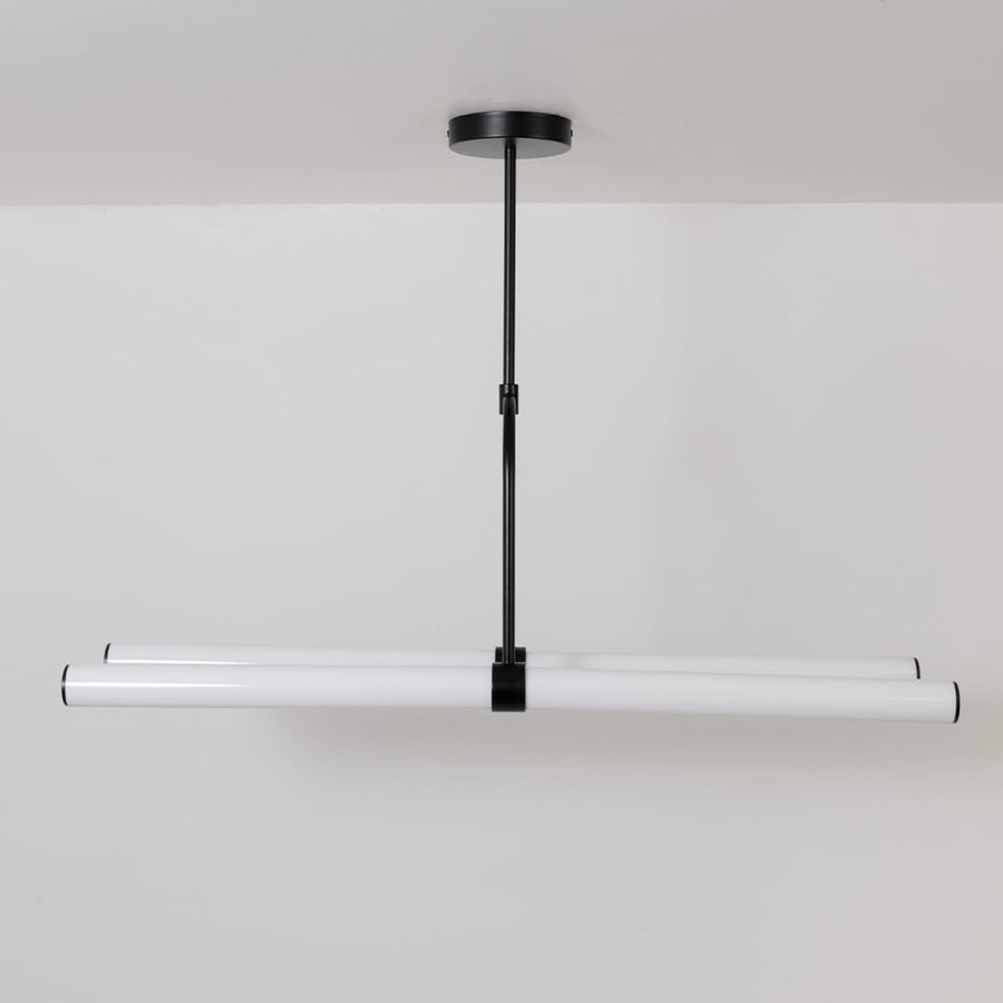 Chandelier with lights off on a white background displaying its minimalist linear form and elegant suspended rods.