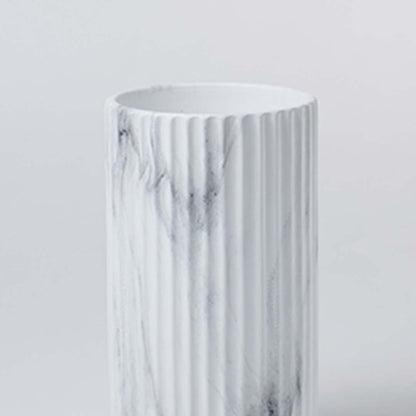 Closeup view of the white ribbed ceramic vase showing marble textured details and a clean contemporary cylindrical design.