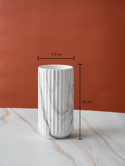 A marble textured cylindrical vase shown with clear measurements of 18 cm height and 9.5 cm width highlighting its sleek compact size for decor use.