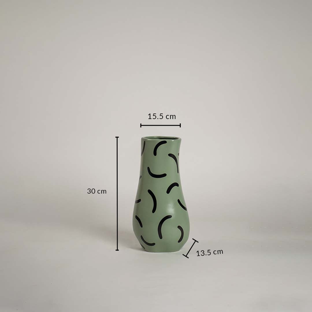 Green ceramic vase with black abstract pattern measuring 30 cm height 15 cm top width and 13 cm base width shown with exact dimensions.