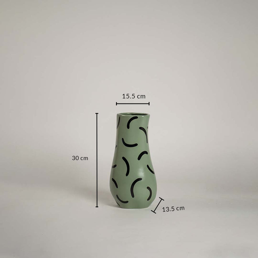 Green ceramic vase with black abstract pattern measuring 30 cm height 15 cm top width and 13 cm base width shown with exact dimensions.