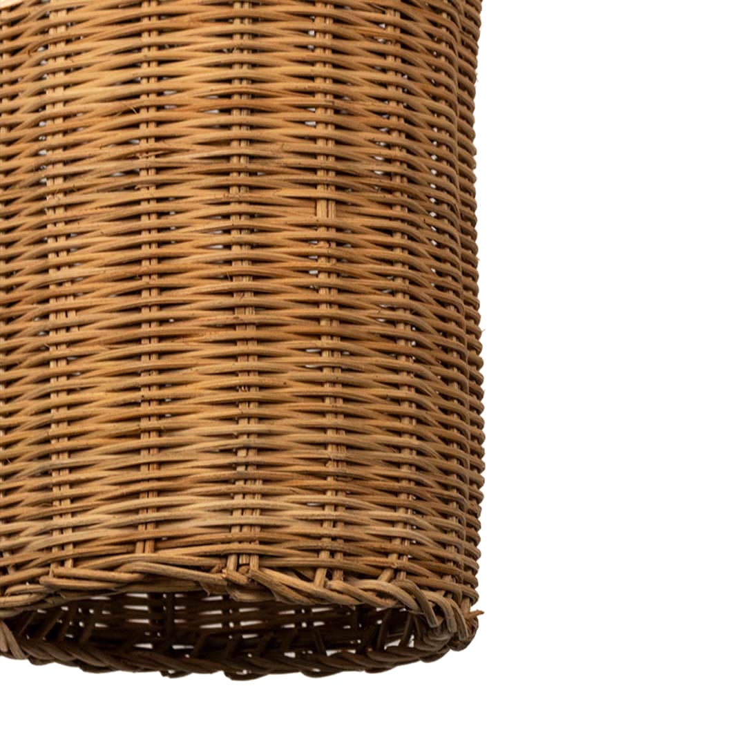 Closeup of woven rattan pendant light with tall bottle shaped wicker shade crafted for rustic bohemian home interiors.