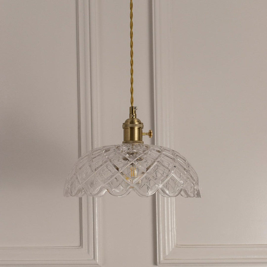 Clear textured glass pendant light with gold chain and vintage details designed for modern interiors.