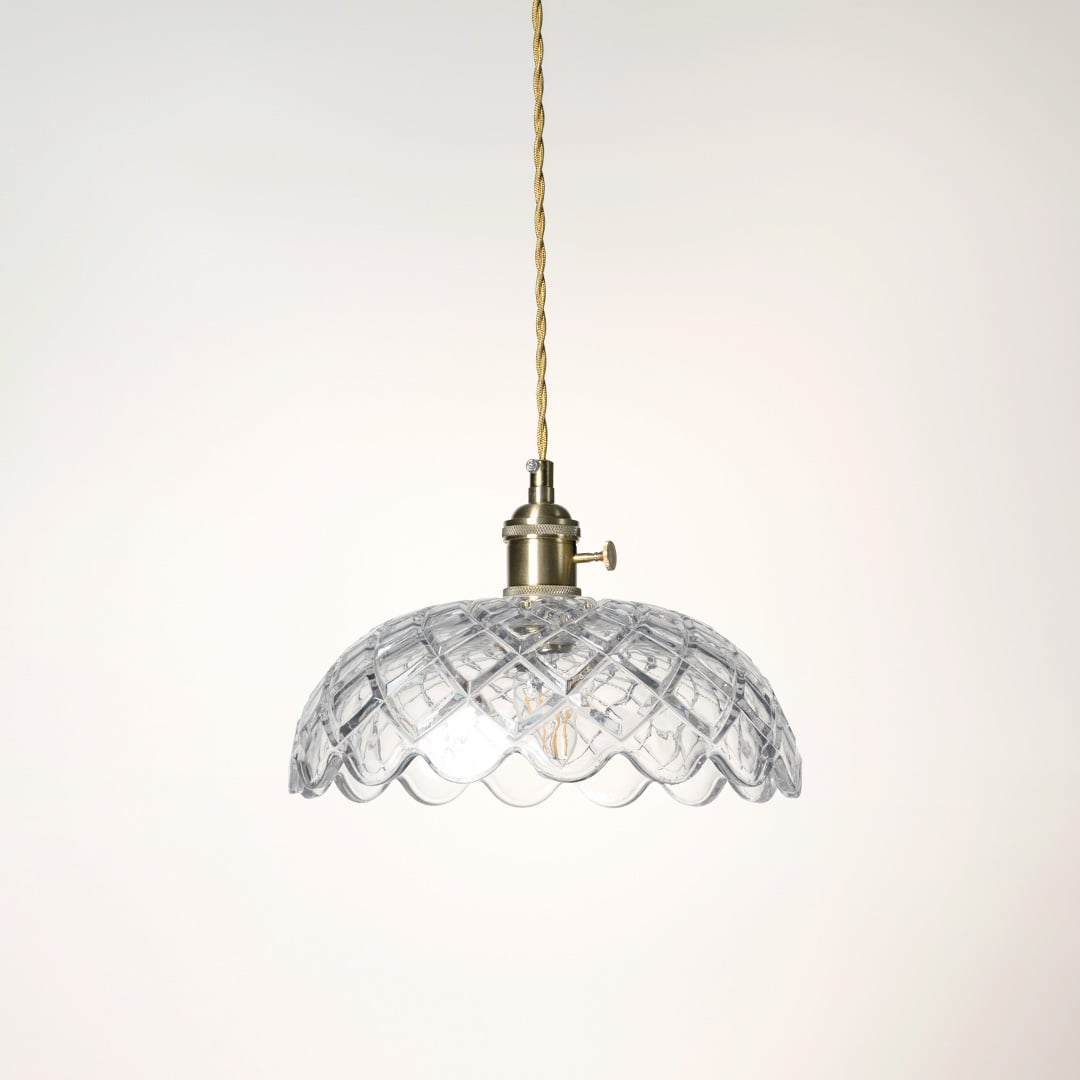 Clear patterned glass pendant light with polished gold fittings crafted for elegant kitchens and dining spaces.