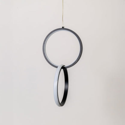 Modern metal dual ring hanging light in black and white shown switched off on white background for minimal wall decor.