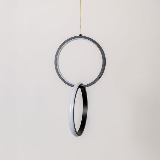 Modern metal dual ring hanging light in black and white shown switched off on white background for minimal wall decor.