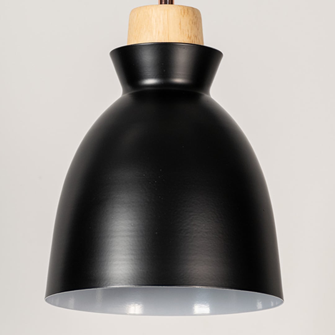 Closeup of black pendant ceiling light with wooden top showing smooth matte finish for modern dining and kitchen lighting decor.