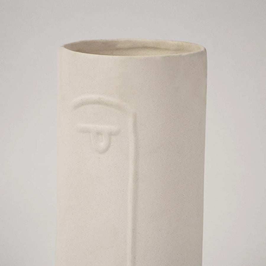 Closeup view of white ceramic face vase capturing its embossed facial details and smooth matte texture perfect for modern tabletop styling.