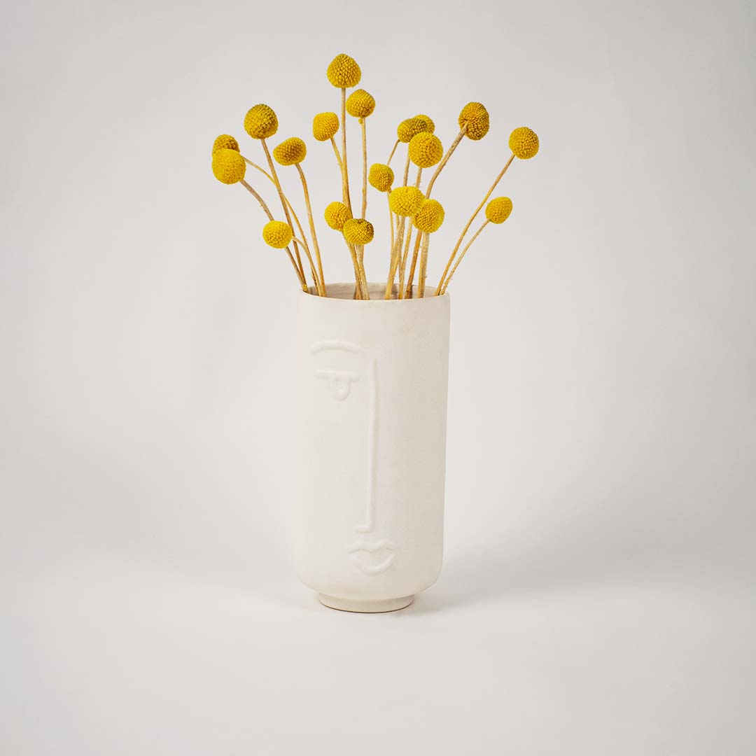 Tall white ceramic face vase shown on a clean white background highlighting its smooth finish and modern artistic design for tabletop decor.