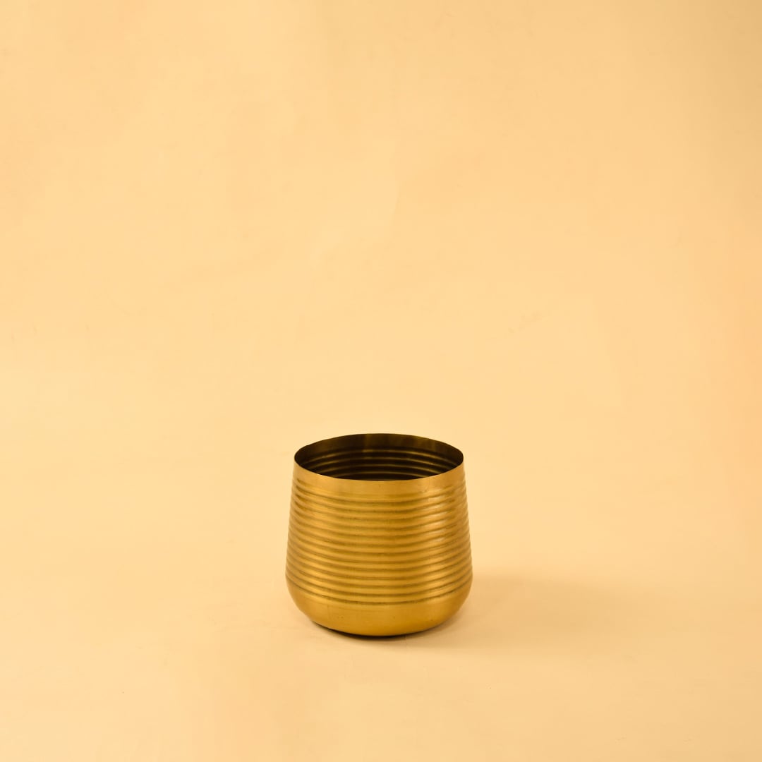 Gold metal planter decor on clean white background ideal for bright modern shelves consoles and tabletop styling.