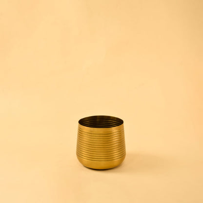 Gold metal planter decor on clean white background ideal for bright modern shelves consoles and tabletop styling.