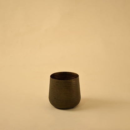 Brown metal planter decor on clean white background ideal for contemporary shelves consoles and tabletop styling.