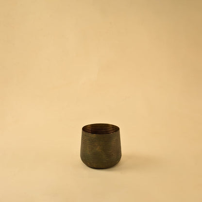 Brown metal planter decor on clean white background ideal for modern home shelves consoles and tabletop styling.