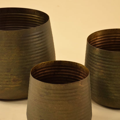 Brown metal planter closeup showing textured metal finish ideal for modern living room tabletop and console decor.