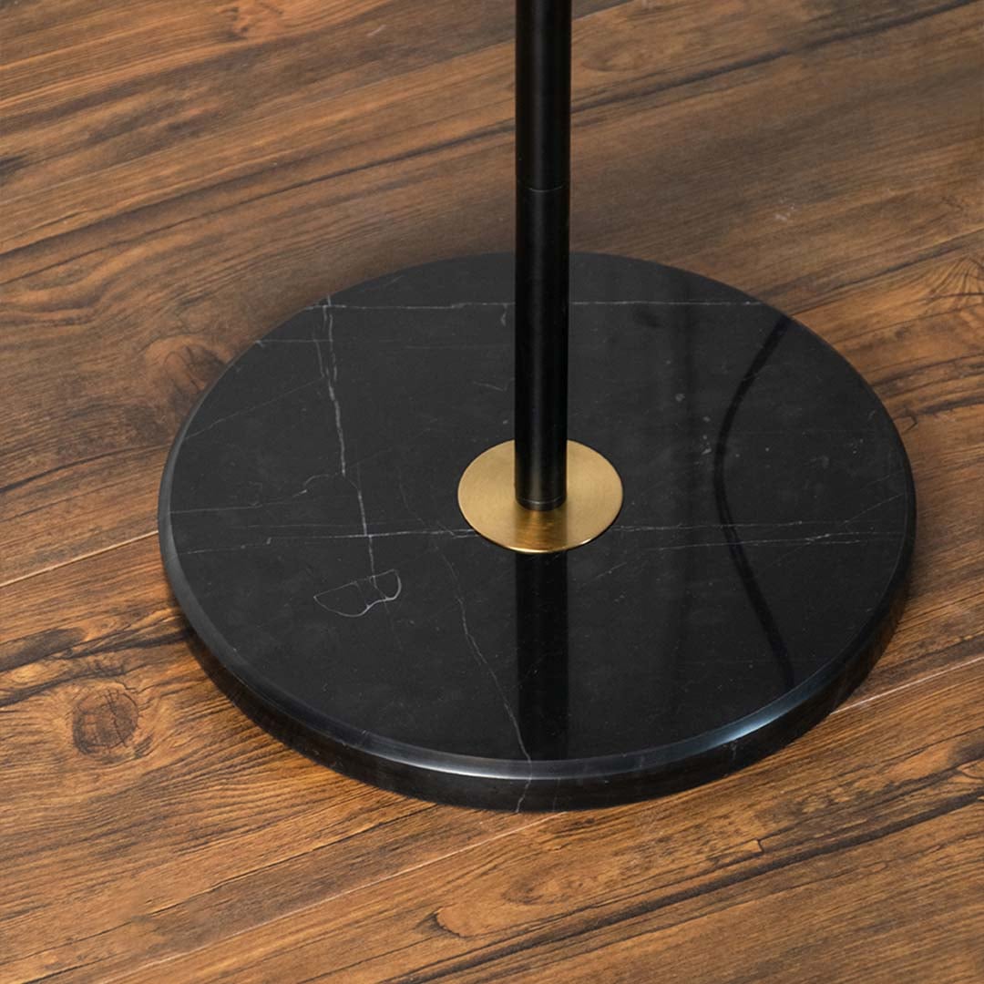 Closeup view of the floor lamp pleated white shade and black base showing fine design details and elegant brass accents.