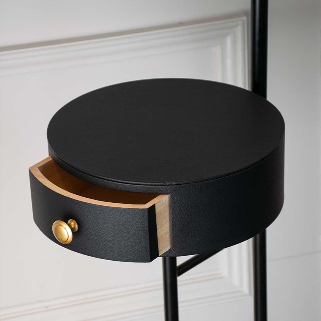 Closeup of modern table lamp head with matte black finish and gold accent highlighting smooth texture and premium lighting design.