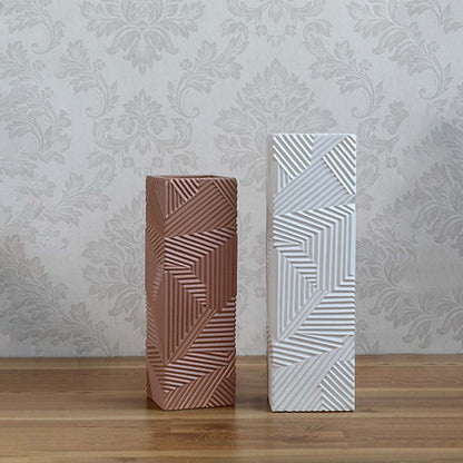 A collection of textured brown geometric vases displayed together highlighting their unique patterns and contemporary decorative appeal.