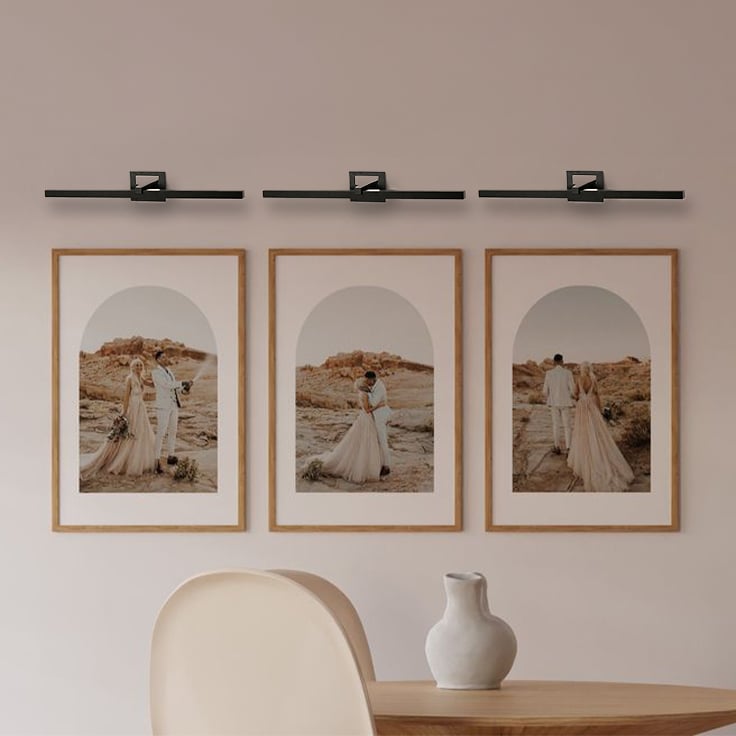 Black metal picture light styled on a modern wall adding warm focused illumination for elegant home decor.