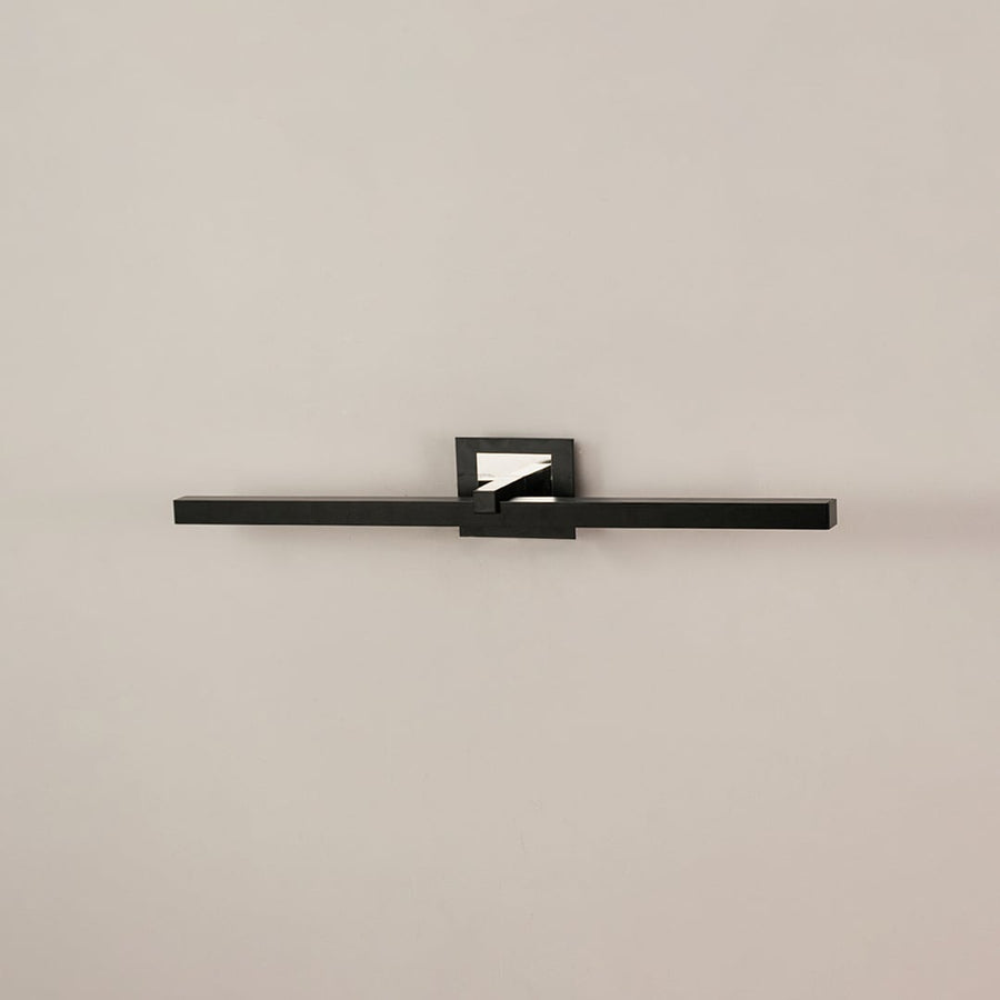 Black metal picture light on a white background with the light off highlighting its bold modern design.