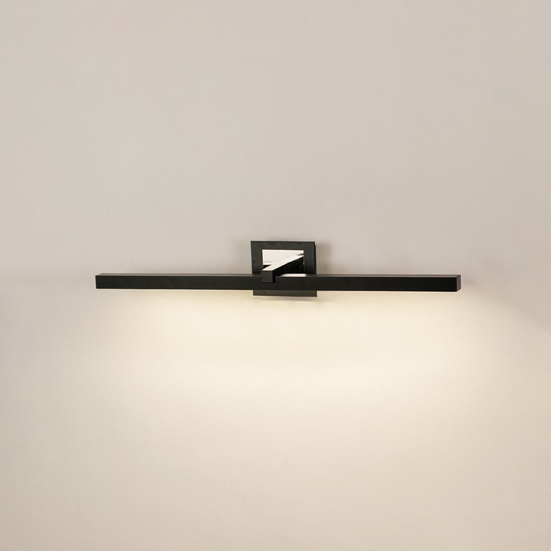 Modern wall light in black metal finish with linear bar design for bathroom or vanity decor lighting white background.