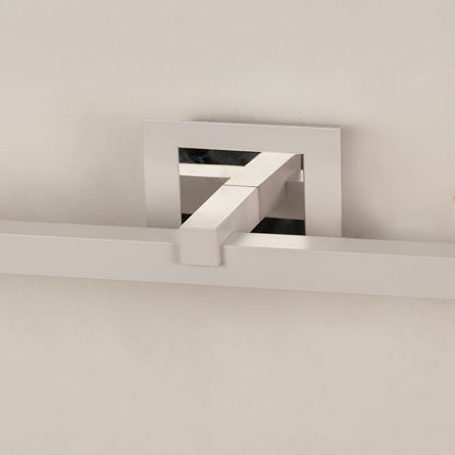 Closeup of silver metal picture light showing smooth finish and detailing with warm focused illumination.