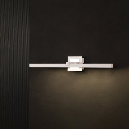 Silver metal picture light glowing warmly on a black background creating a bold modern wall lighting effect.
