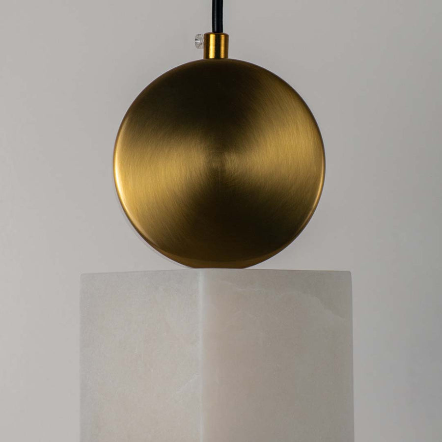 Closeup of brushed gold pendant light with white fabric shade showcasing premium craftsmanship.