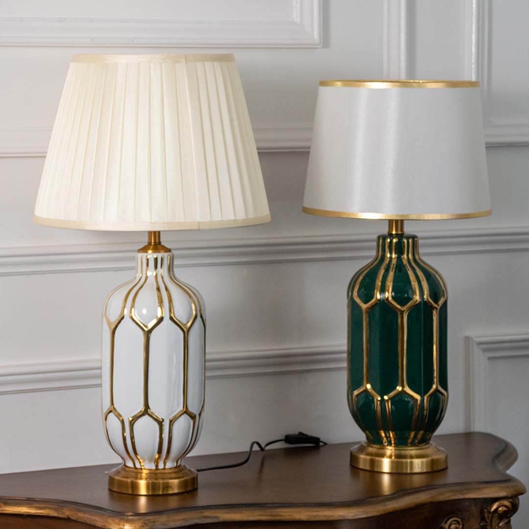 Pair of white and green ceramic table lamps with gold metal detailing and soft shades turned off showcasing modern luxury and timeless design.