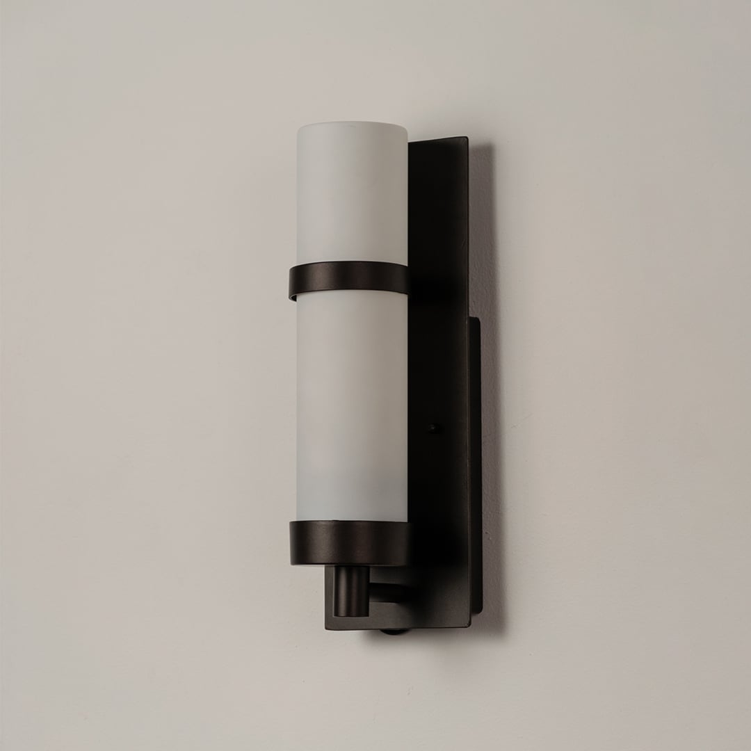 Black metal wall lamp with frosted glass shade displayed on white background showing sleek minimalist indoor lighting.