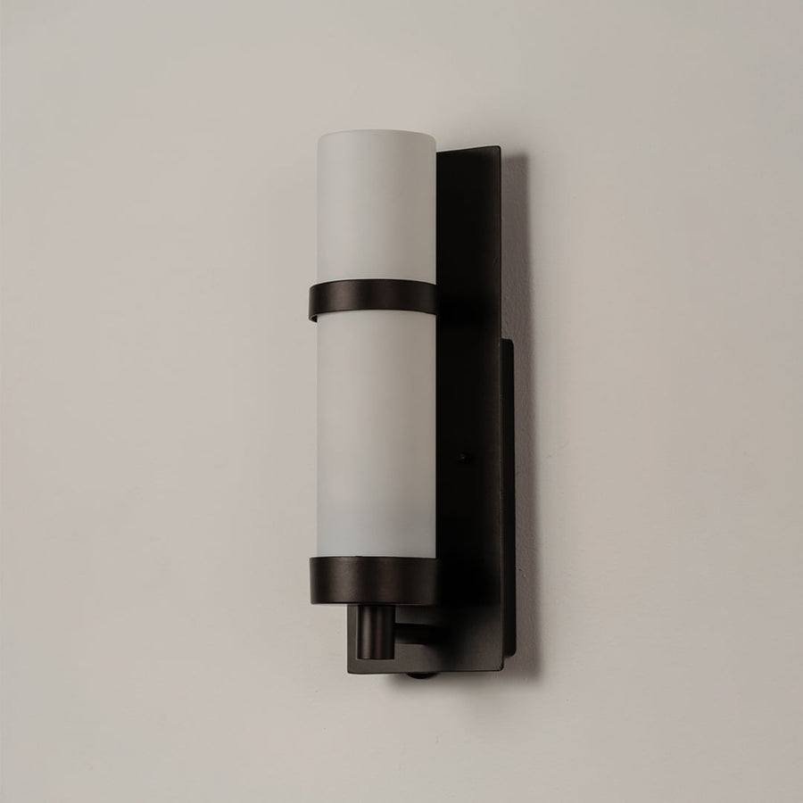 Black metal wall lamp with frosted glass shade displayed on white background showing sleek minimalist indoor lighting.
