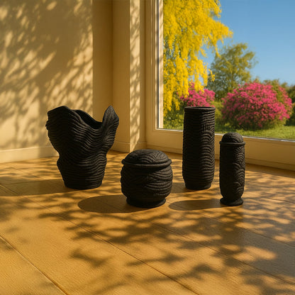 Black ceramic decorative sculpture set styled in a sunlit space for artistic contemporary home decor arrangements.