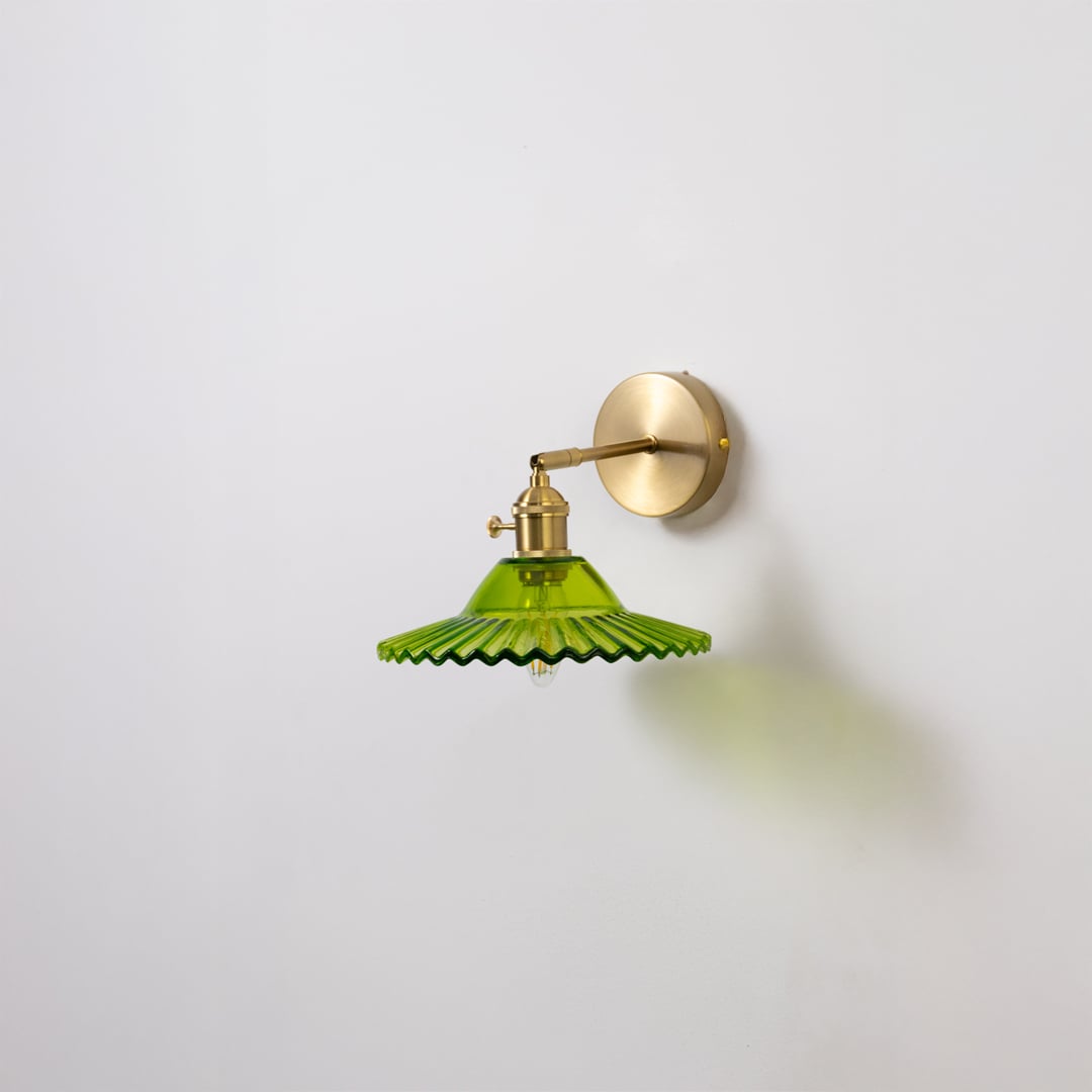 Green glass and gold metal wall light for modern bedroom hallway and elegant home decor styling spaces.