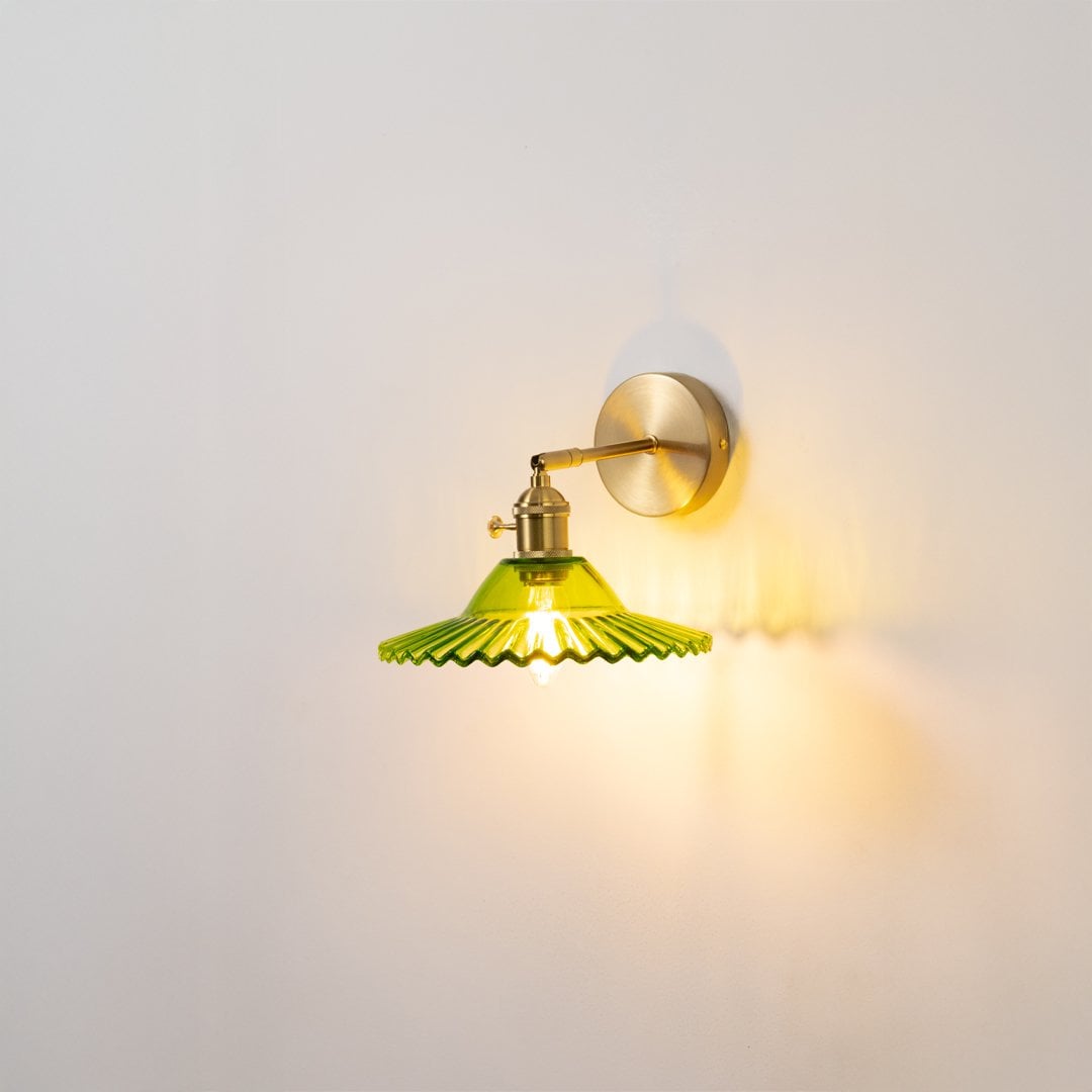 Gold metal wall light with green glass shade for elegant modern ambient lighting decor styling ideas.