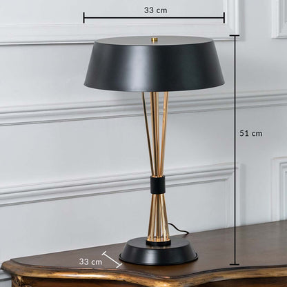 Black and gold table lamp with tapered rod base and wide shade shown with dimensions of 33 cm width 51 cm height and 33 cm depth ideal for office or bedside placement.