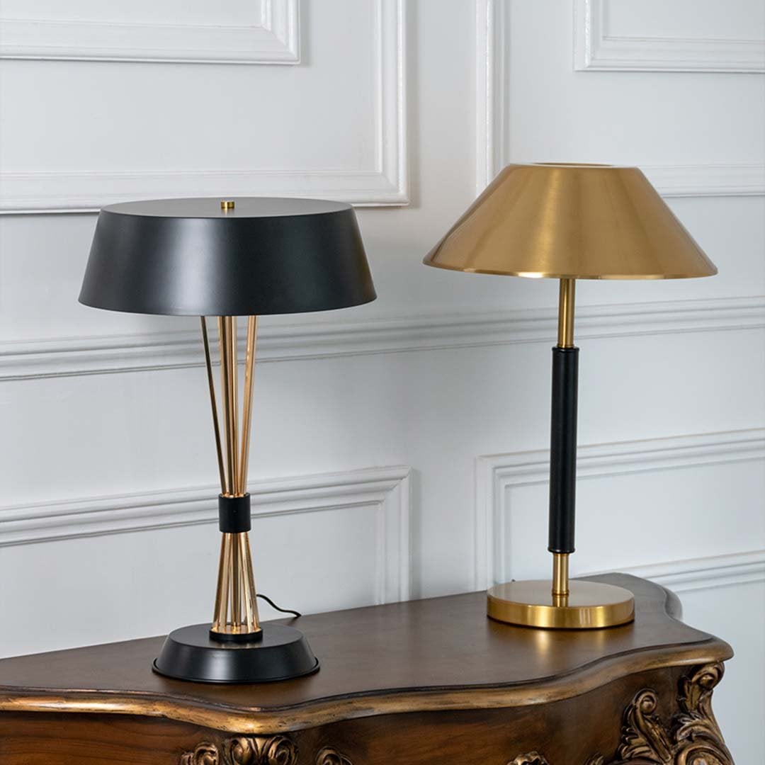 Black and gold table lamps with wide shades displayed together with lights off showcasing elegant modern design for home or office decor.