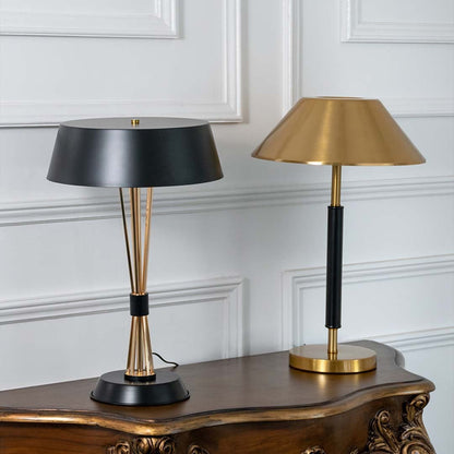 Black and gold table lamps with wide shades displayed together with lights off showcasing elegant modern design for home or office decor.