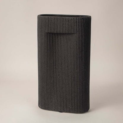 Side angle view of black rectangular ceramic vase with grooved texture perfect for living room or office interior styling.