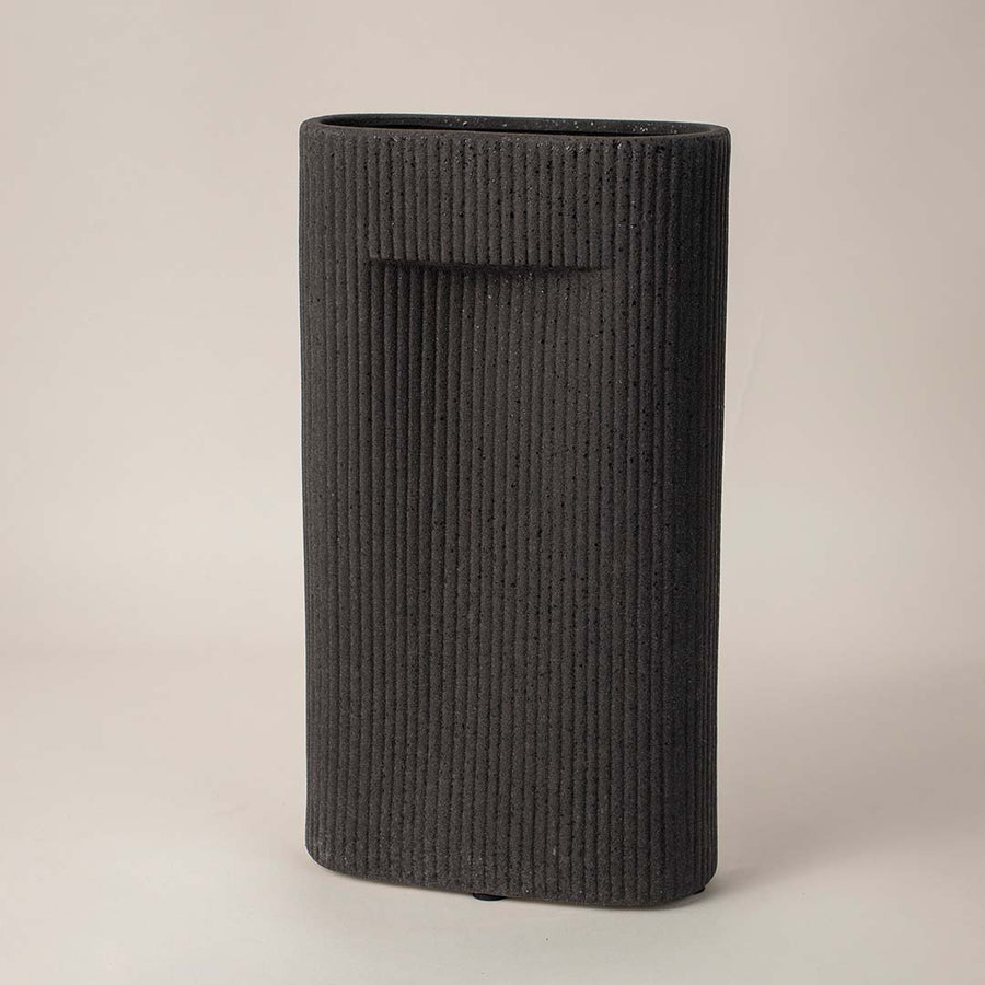 Side angle view of black rectangular ceramic vase with grooved texture perfect for living room or office interior styling.