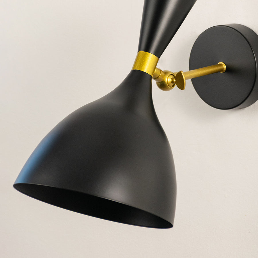 Modern black metal spotlight wall light with brass accents for stylish contemporary interior decor.