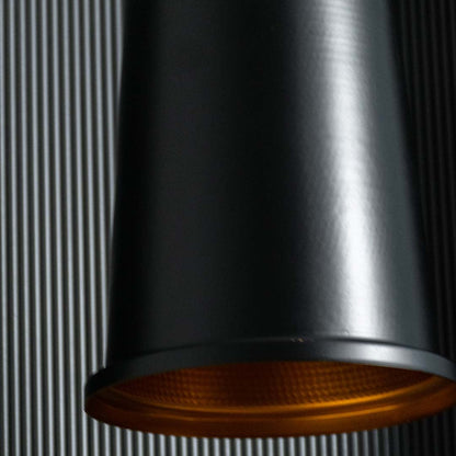 Detailed closeup of the pendant light showing the gold inner reflector and textured diffuser for warm focused illumination.
