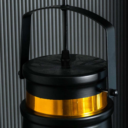 Closeup view of the black and gold metal pendant light showing its top handle and gold band with a refined industrial design.