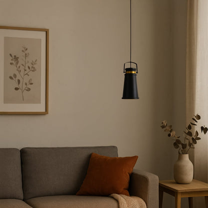 Warm lifestyle scene featuring a black and gold metal pendant light turned on casting a soft glow over a cozy neutral living room setting.