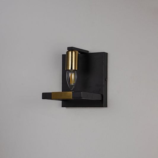 Black and gold wall light with metal frame and exposed bulb shown off on white background for modern interior wall decor.