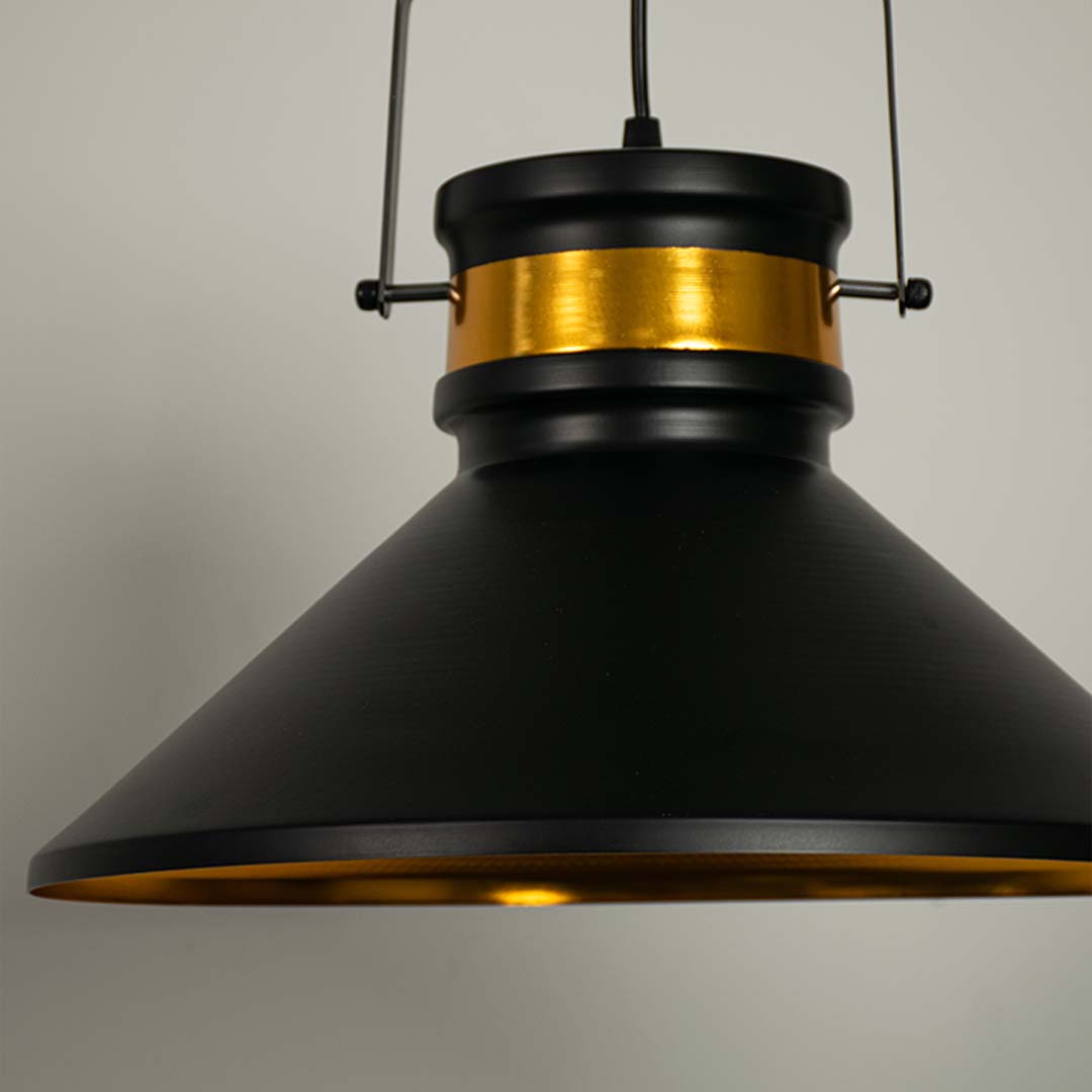Closeup of black pendant light with detailed golden inner lining showing premium modern craftsmanship.