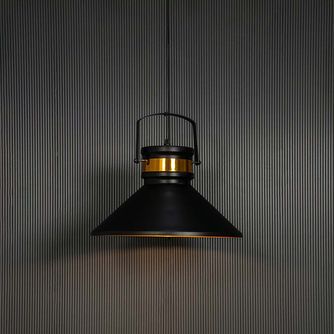 Matte black pendant light turned on with golden shade interior glowing against black background for luxury interiors.