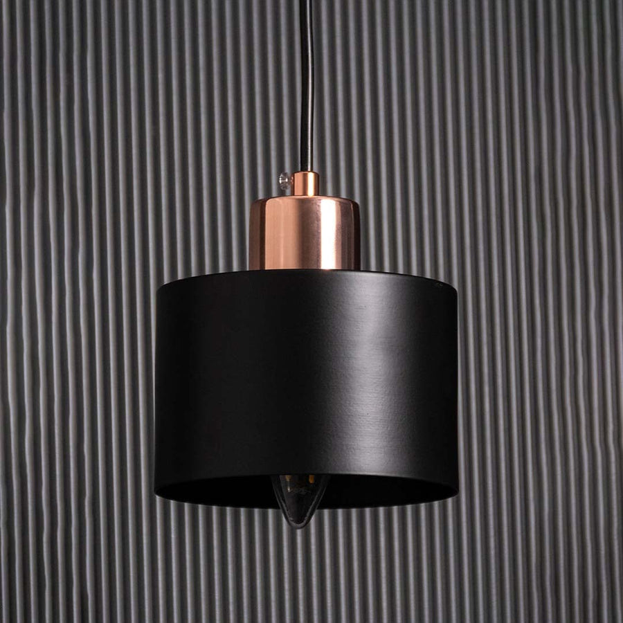 Detailed closeup of gold and amber glass wall light highlighting the glossy globe texture and elegant metal frame for contemporary interior styling.