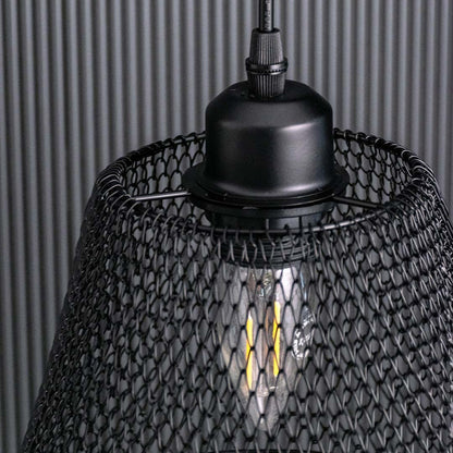 Detailed view of the black mesh pendant light showing the woven metal pattern and warm bulb glow for a textured modern industrial look.