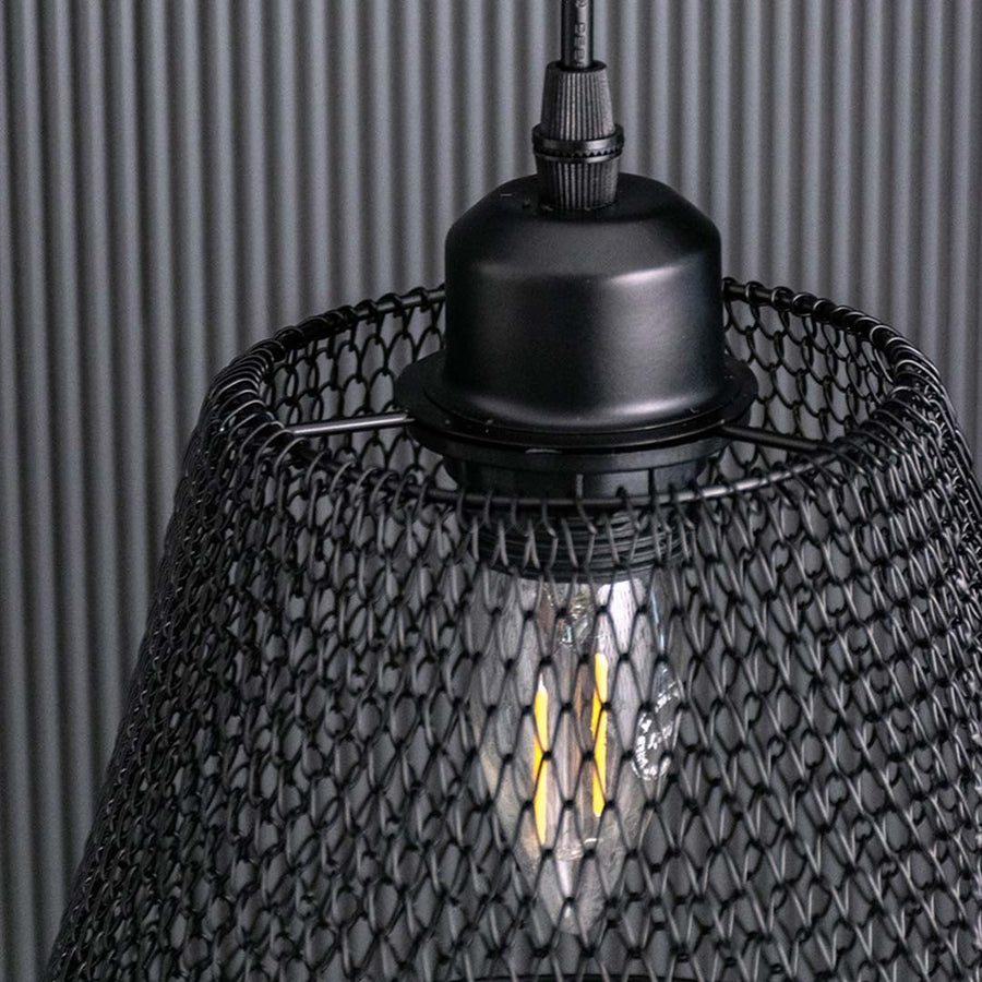 Detailed view of the black mesh pendant light showing the woven metal pattern and warm bulb glow for a textured modern industrial look.